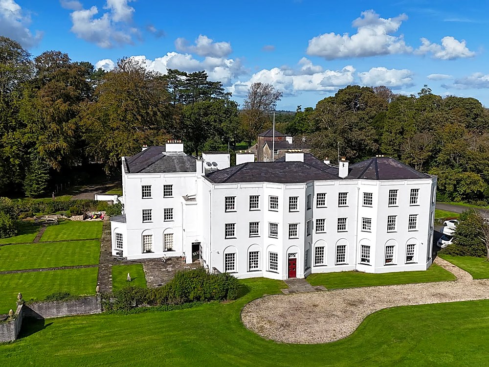 Aerial view of Vaynol Hall across the lake